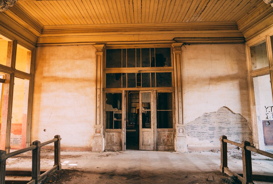 Explore the haunting beauty of an abandoned mansion interior with decaying walls and vintage charm.